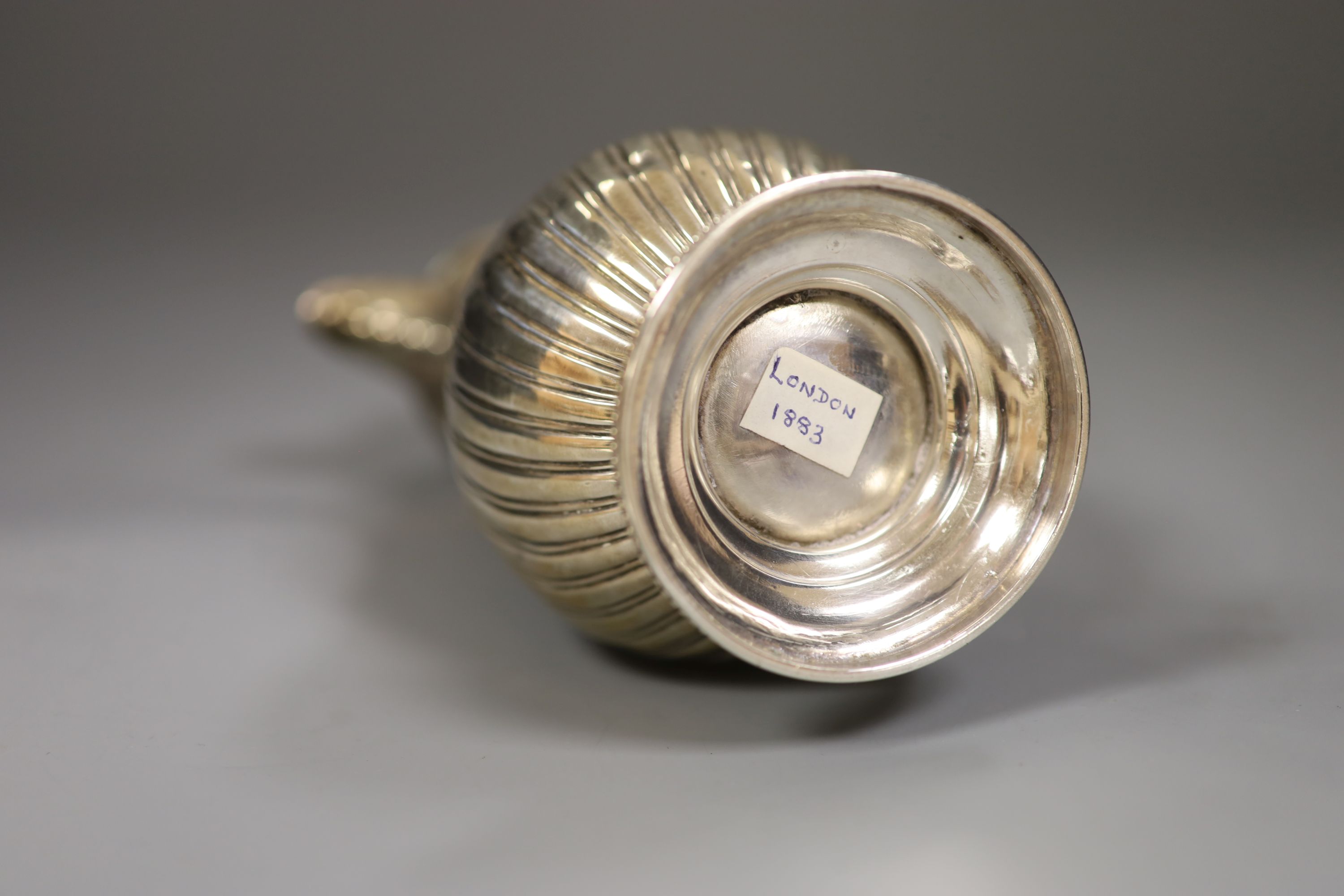 A Victorian fluted silver hot water pot, Charles Stuart Harris, London, 1883, 22.6cm, gross 11.5oz.